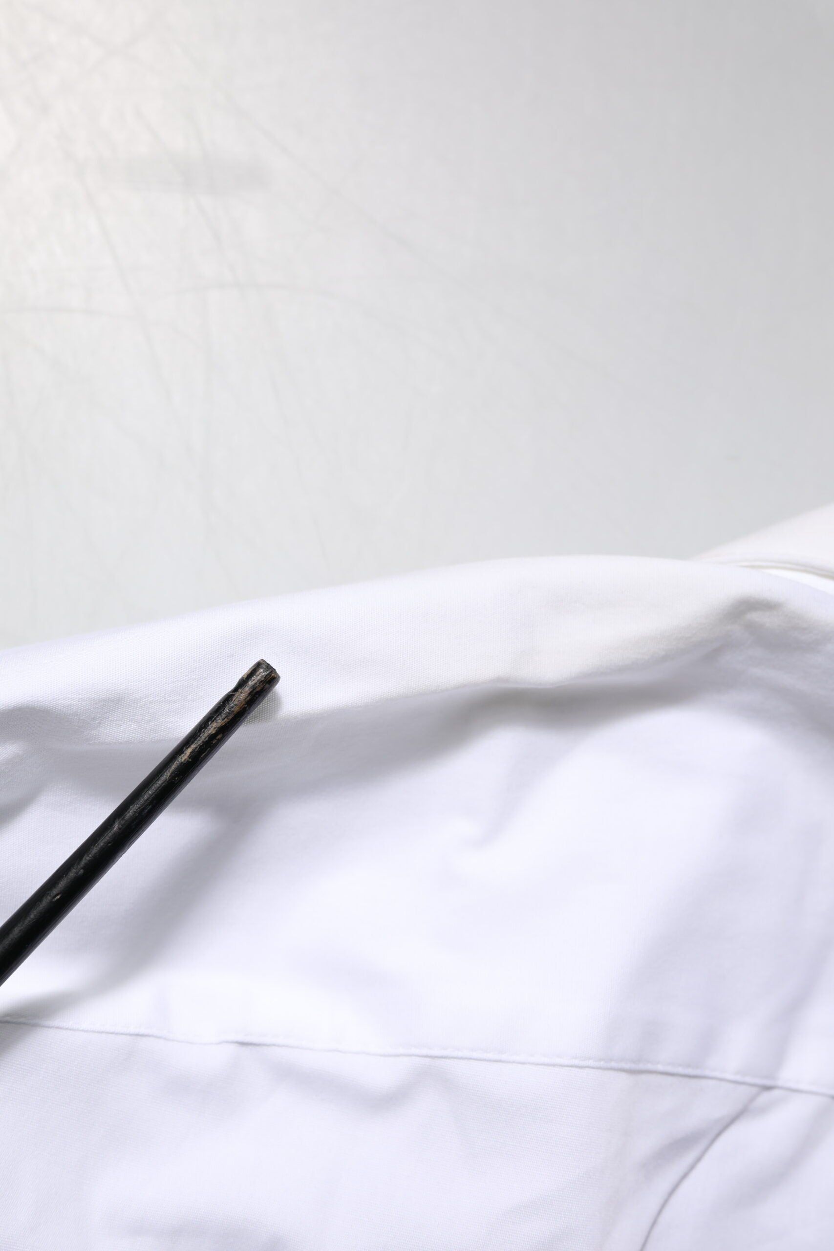 A white collared dress shirt with gold accents from Dolce & Gabbana