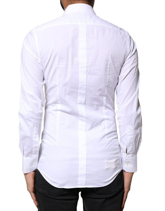 A white cotton dress shirt with long sleeves and gold accents from the brand Dolce & Gabbana