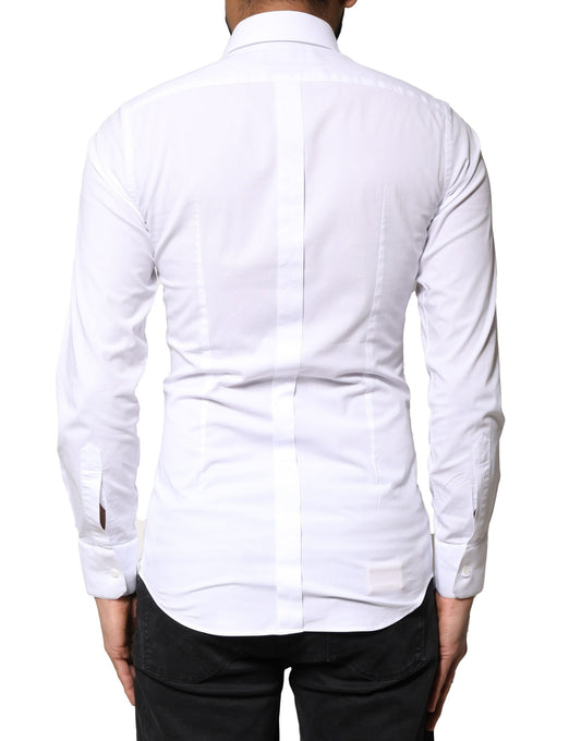 A white dress shirt with gold accents, long sleeves, and a collar. It is designed by Dolce & Gabbana and made