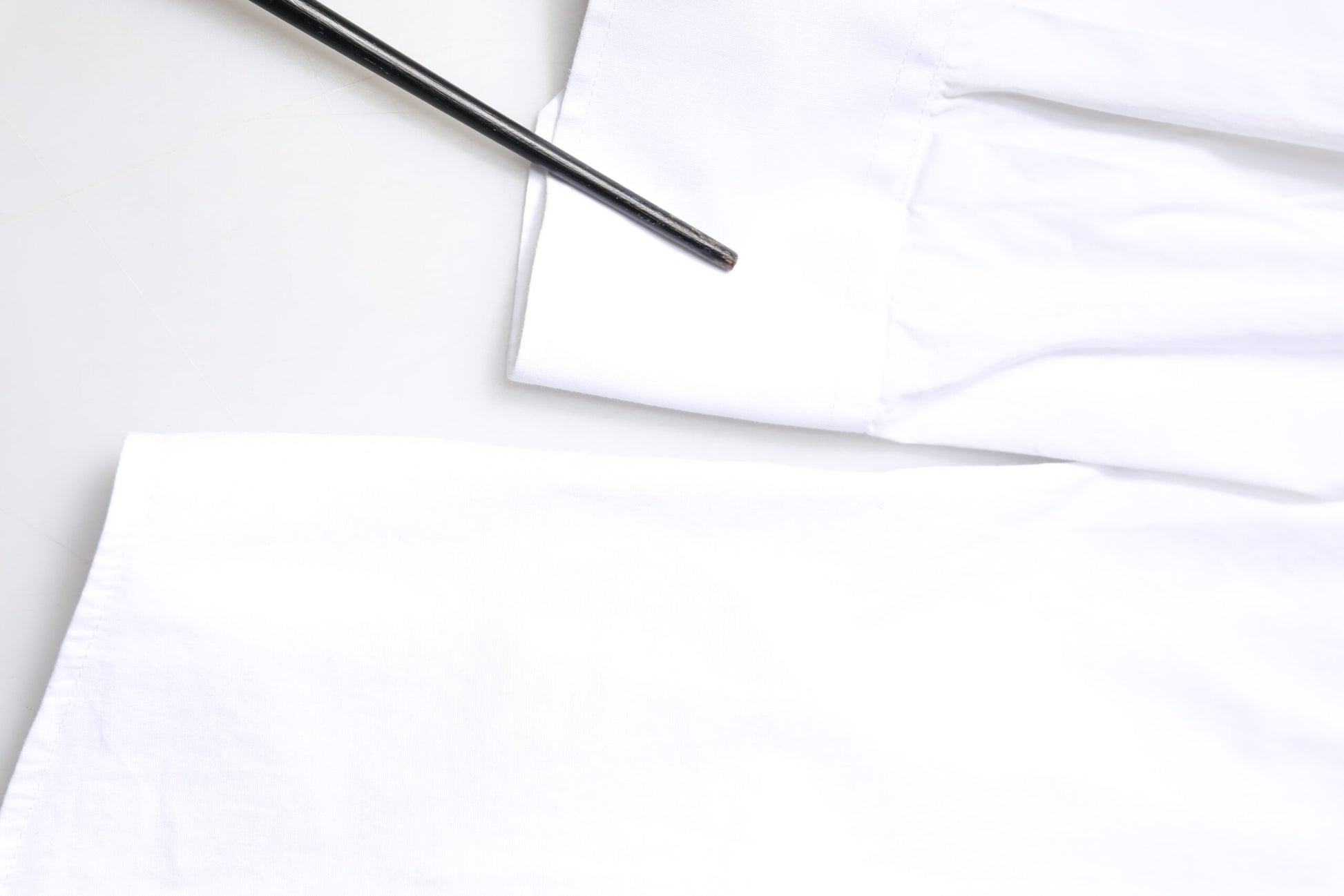 A white cotton long sleeve dress shirt with gold accents from the brand Dolce & Gabbana