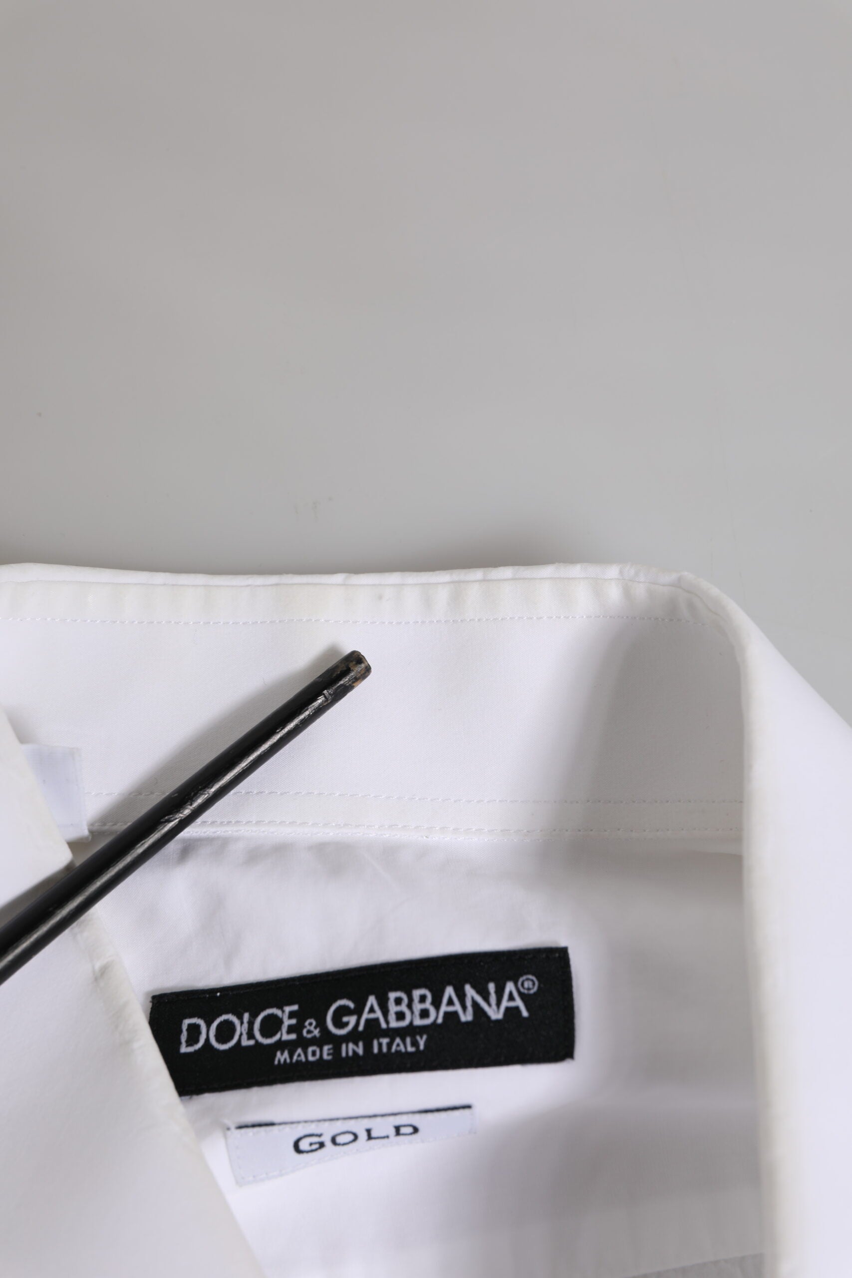 A white cotton dress shirt with a gold label from Dolce & Gabbana