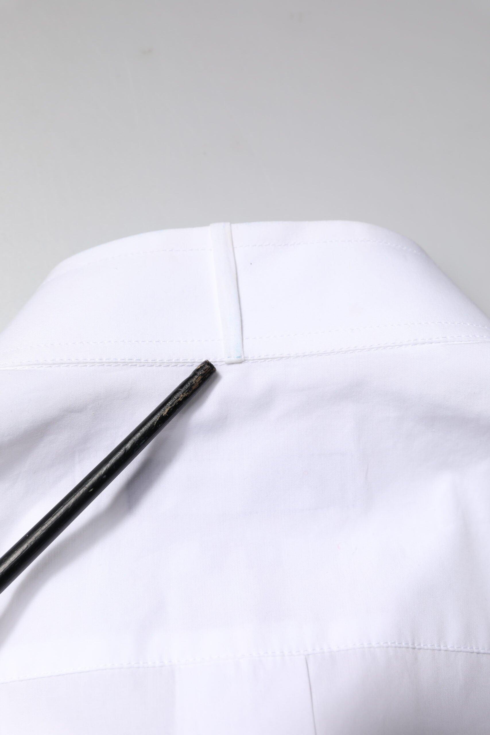 A white cotton poplin bib formal men's dress shirt with gold accents