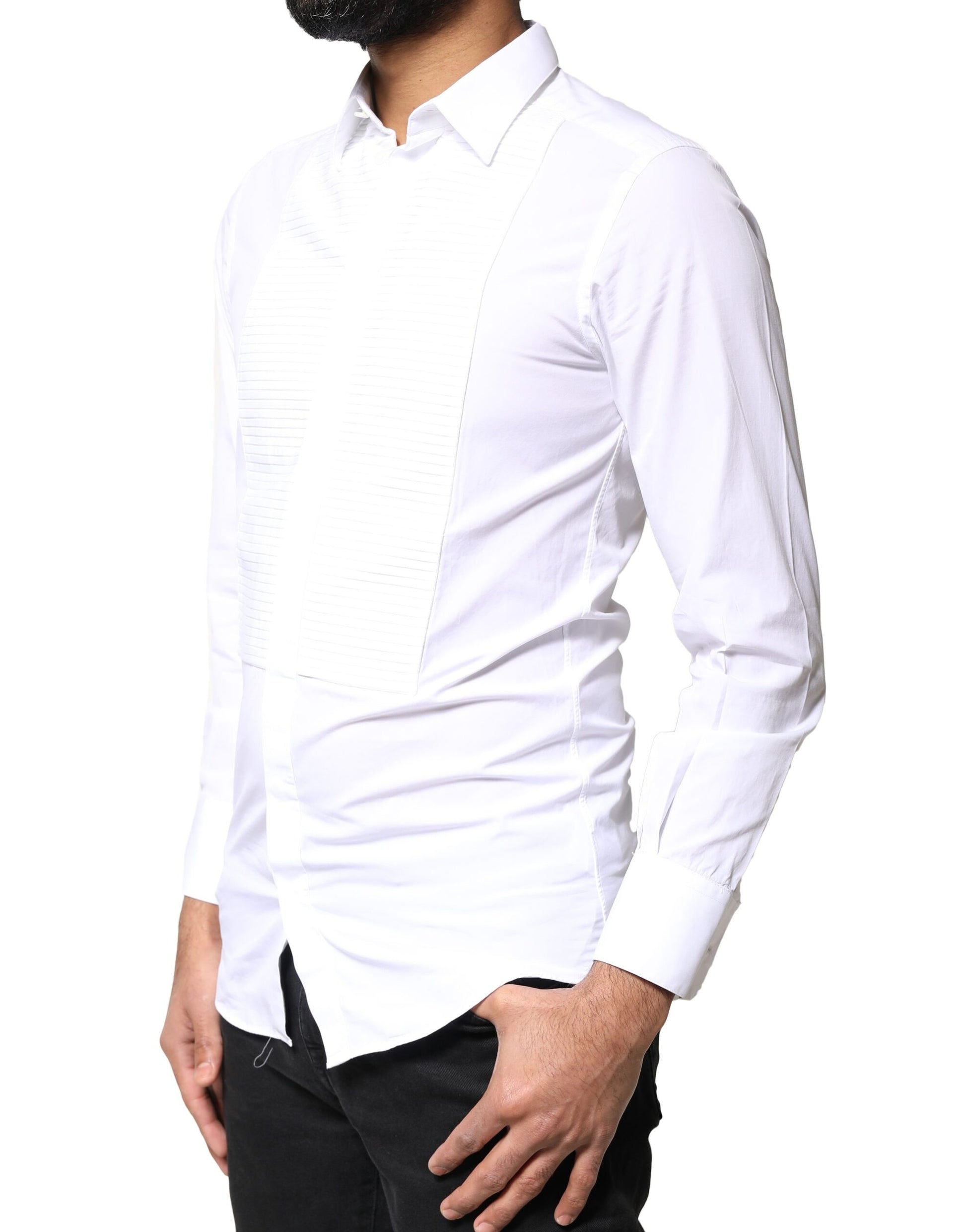 A man wearing a white shirt with a gold bib front