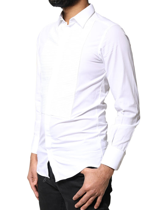 A man wearing a white shirt with a gold bib front