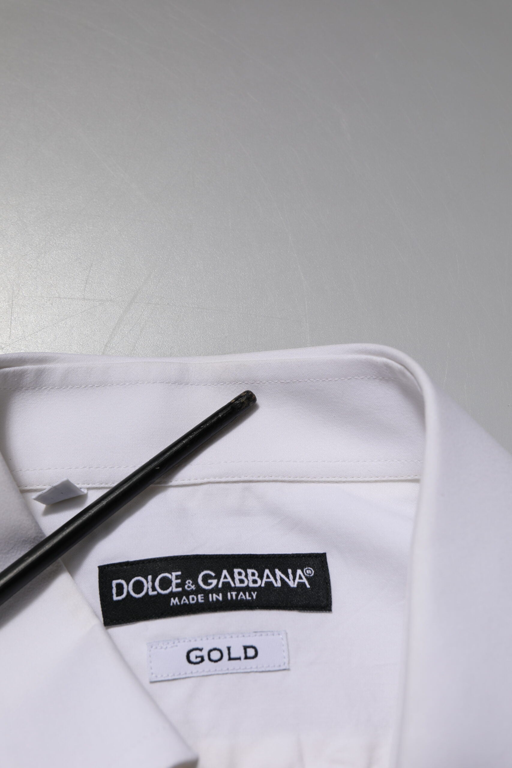 A white cotton poplin dress shirt with a gold label from Dolce & Gabbana