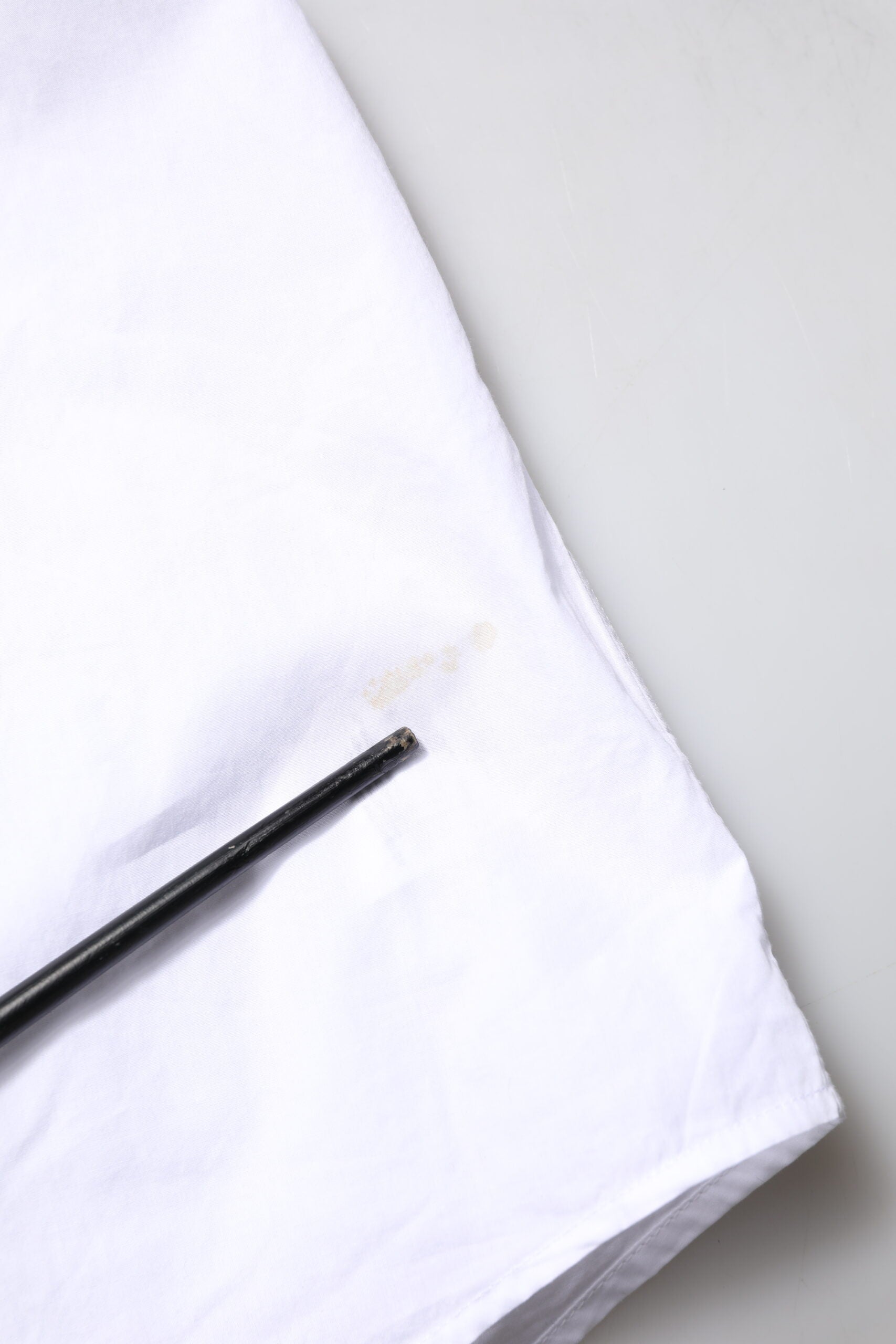 A white cotton poplin formal dress shirt with gold accents from the brand Dolce & Gabbana