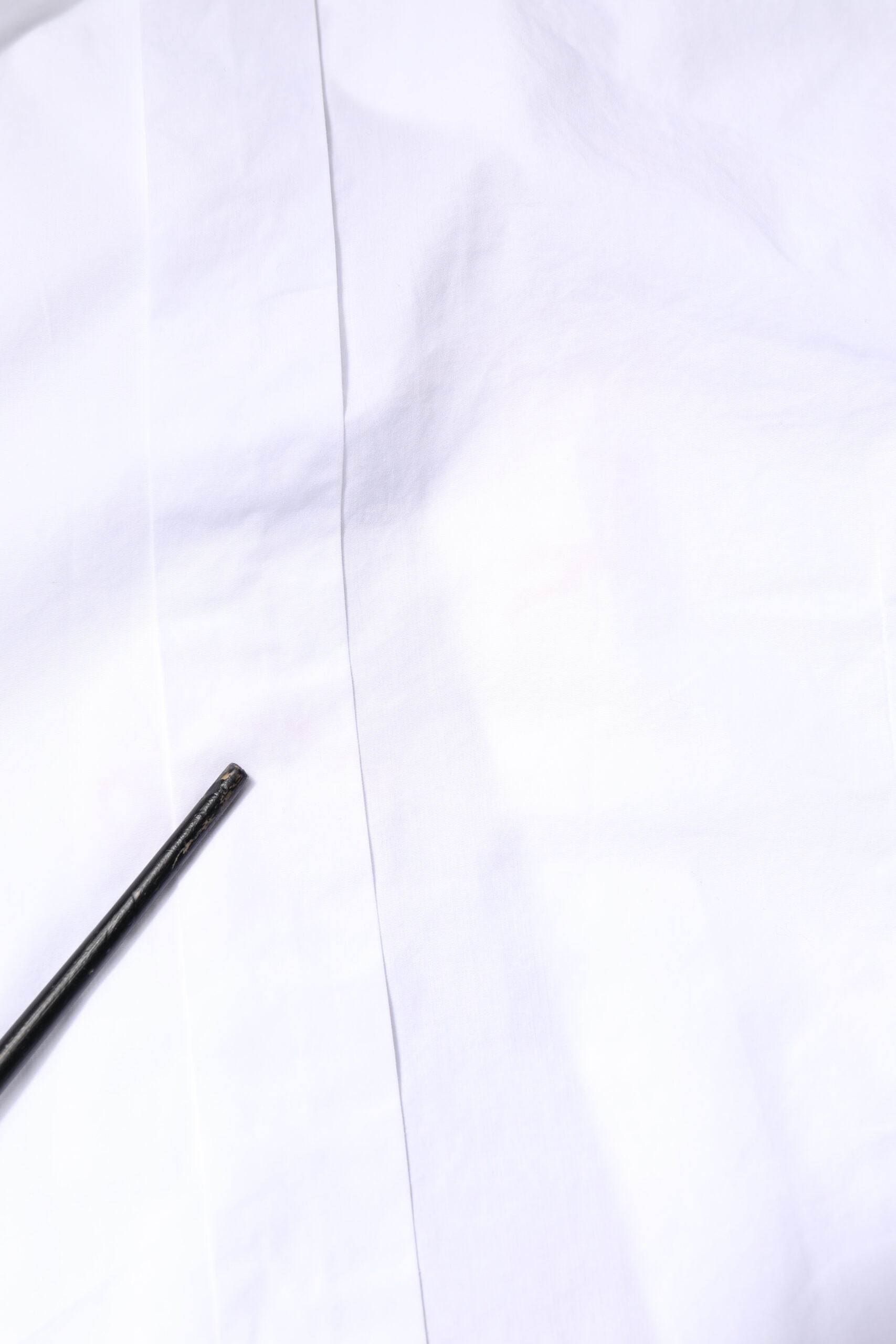 A white cotton poplin bib formal dress shirt with gold accents