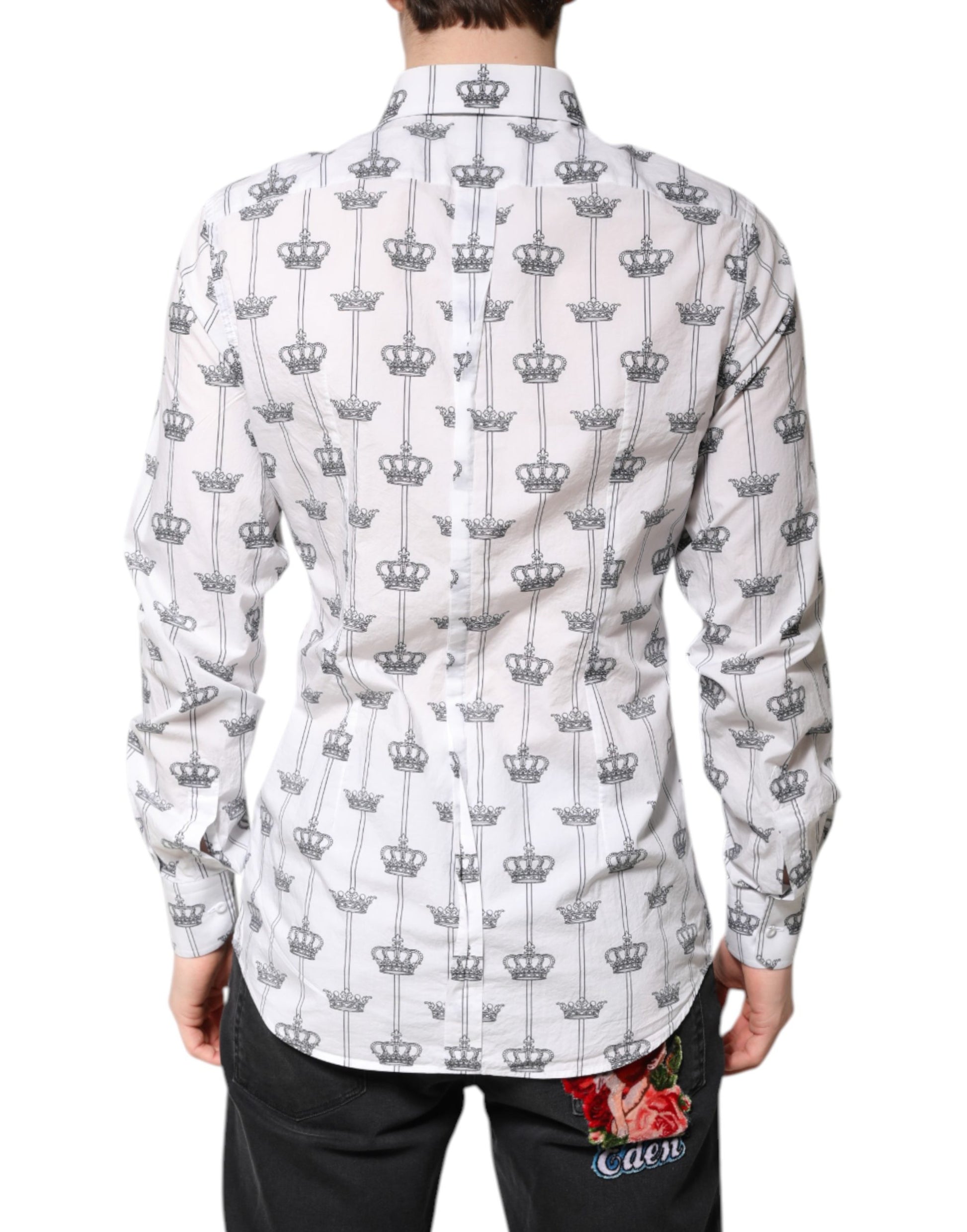 A white shirt with a gold crown pattern on the back