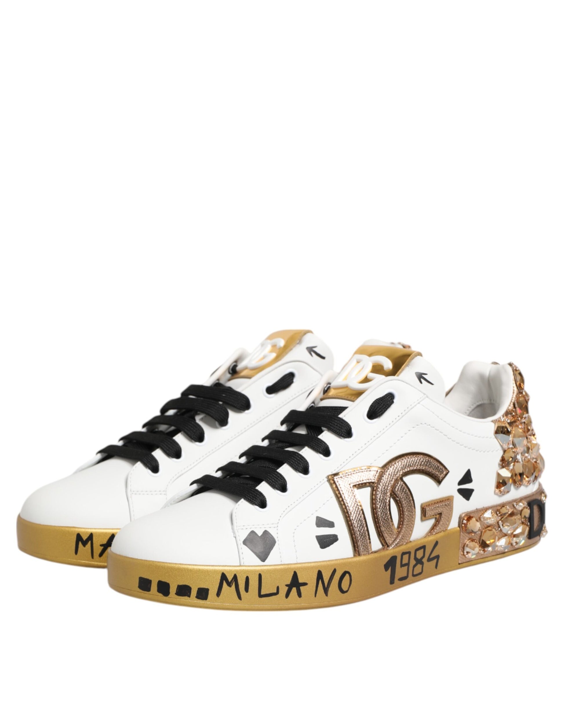 Pair of white sneakers with gold accents and black laces