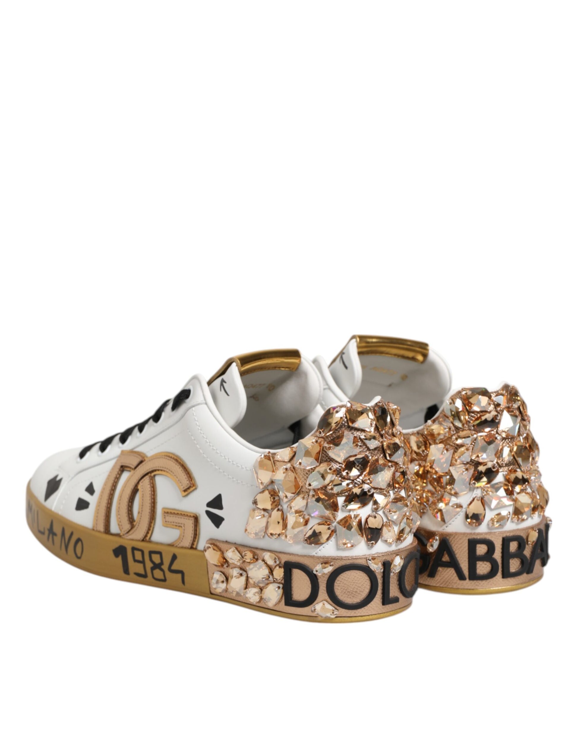 White sneakers with gold accents and sparkly embellishments on sides