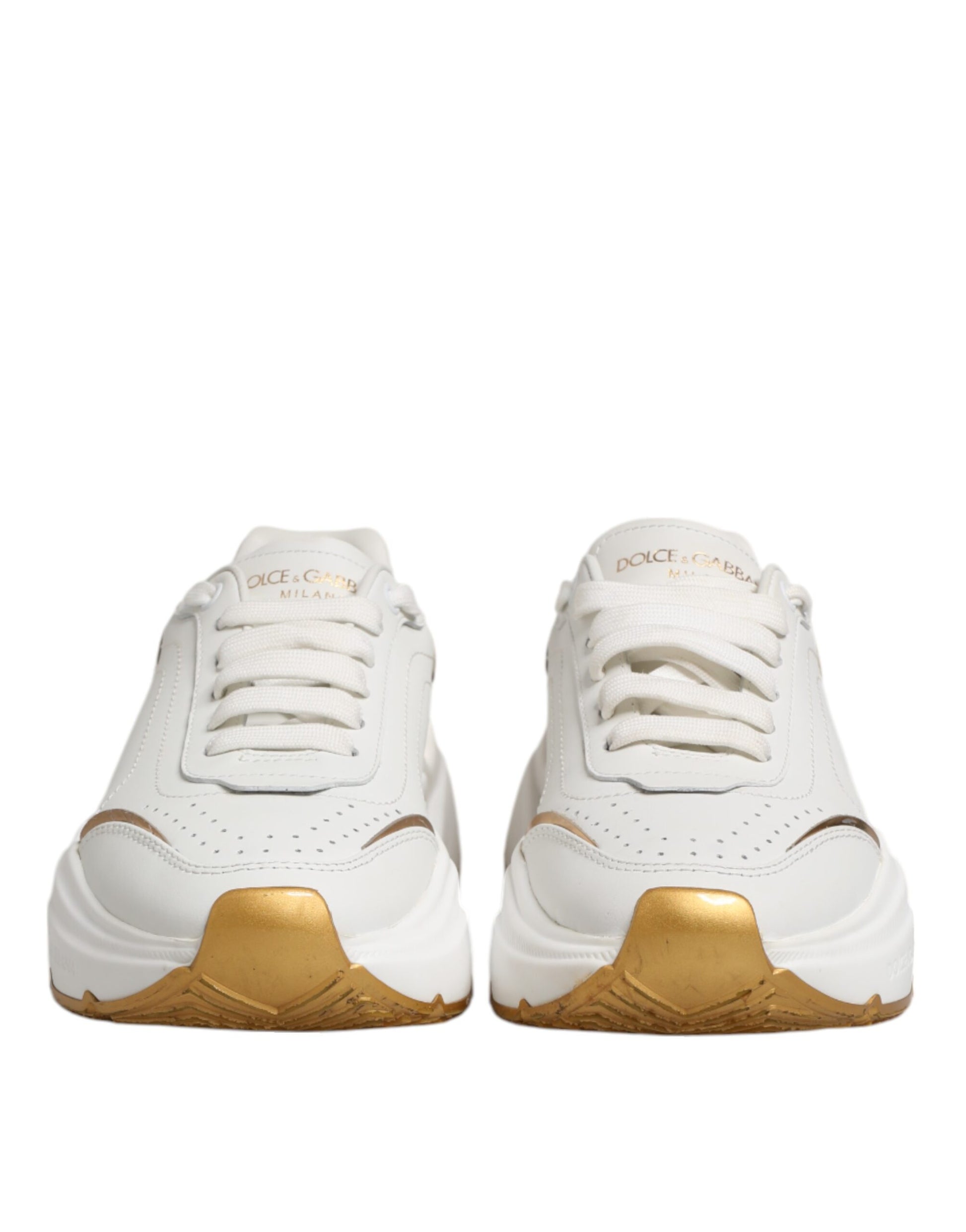 Pair of white gold leather sneakers with laces and logo on side