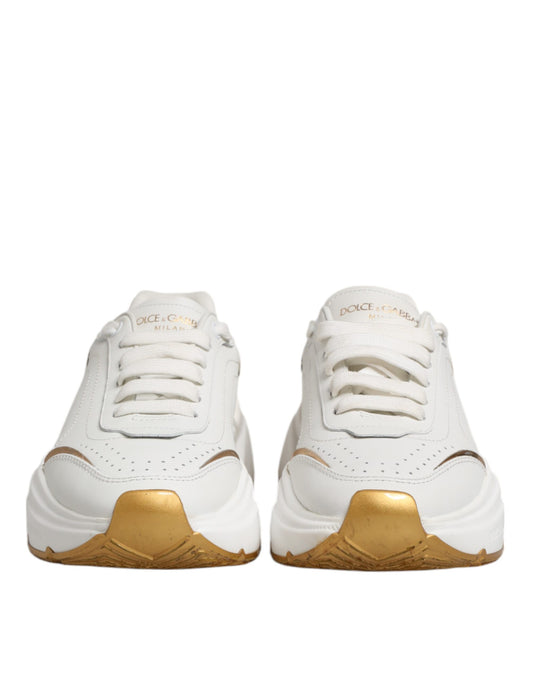 Pair of white gold leather sneakers with laces and logo on side