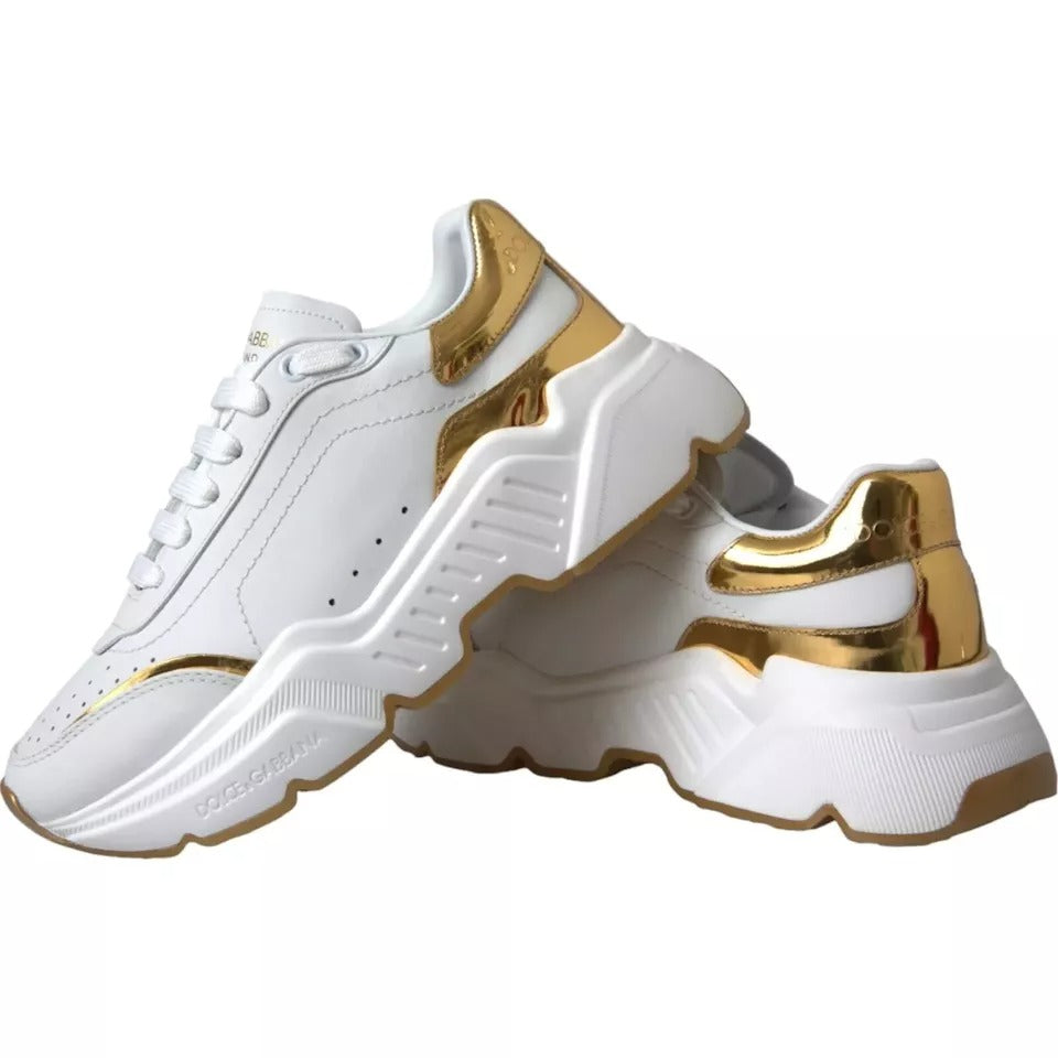 Pair of white sneakers with gold accents