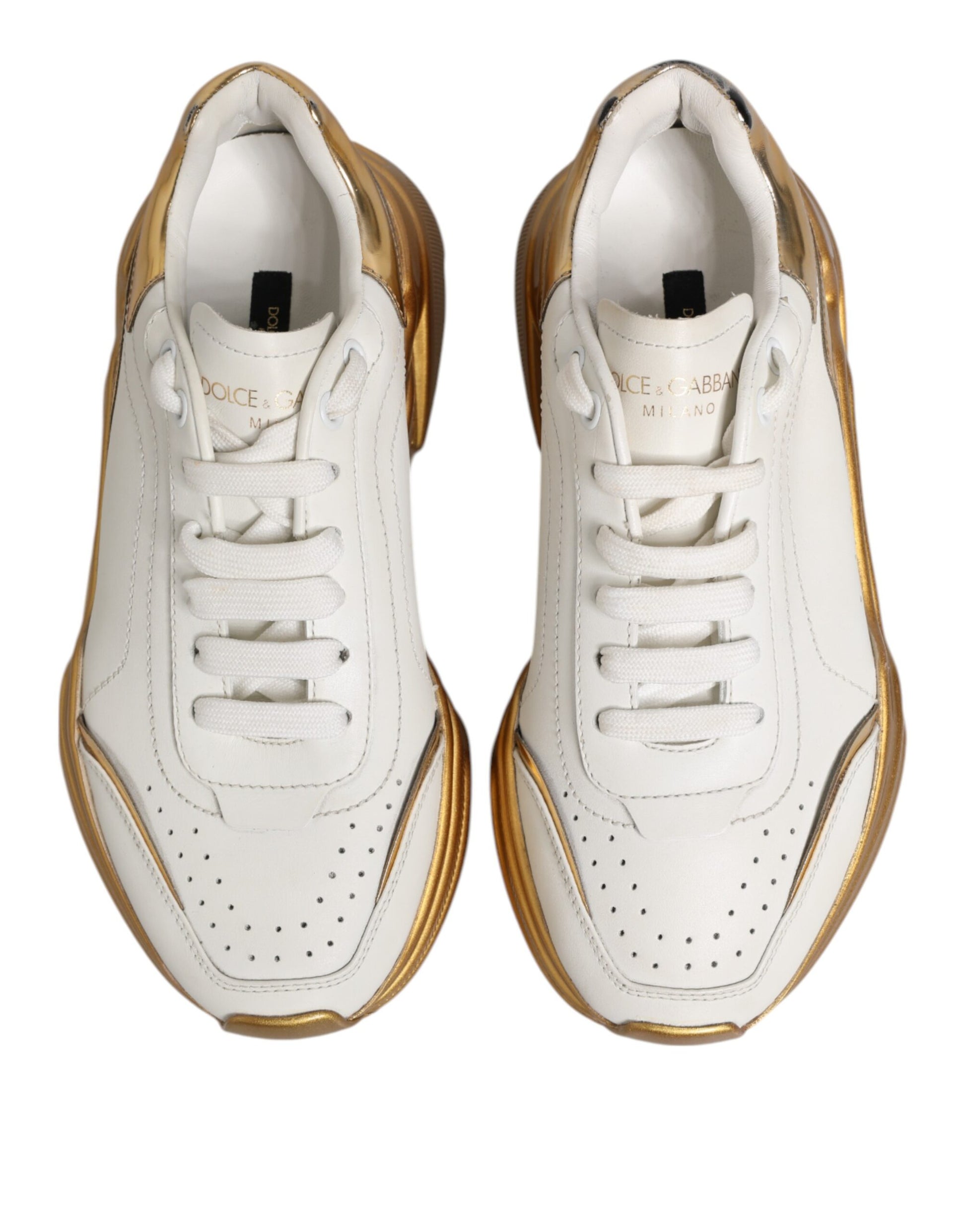 Pair of white gold leather sneakers with black laces