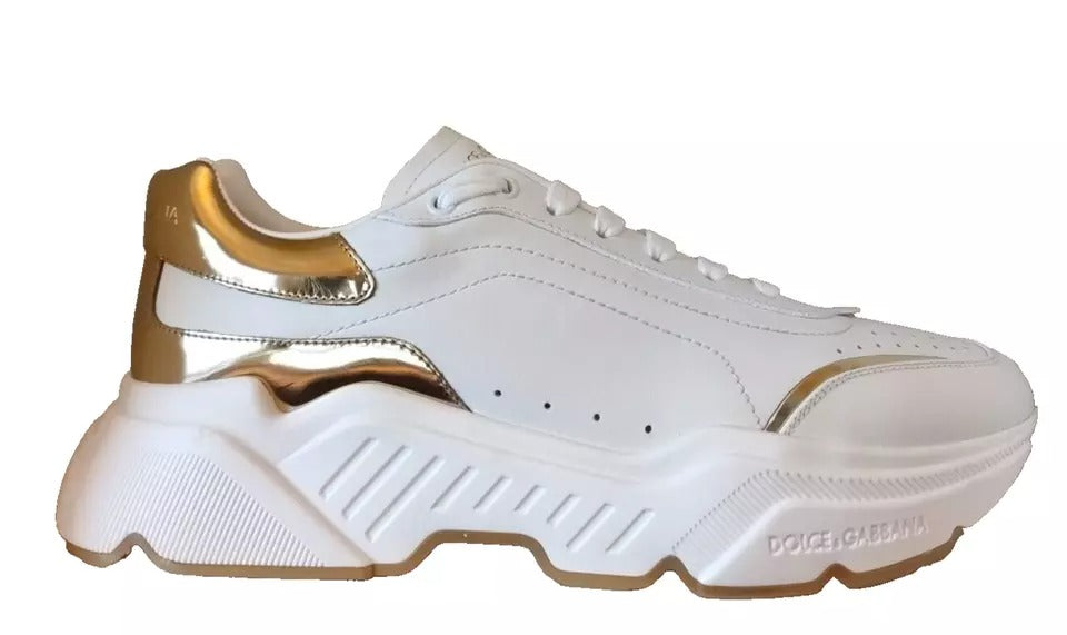 White sneaker with gold accents and black sole