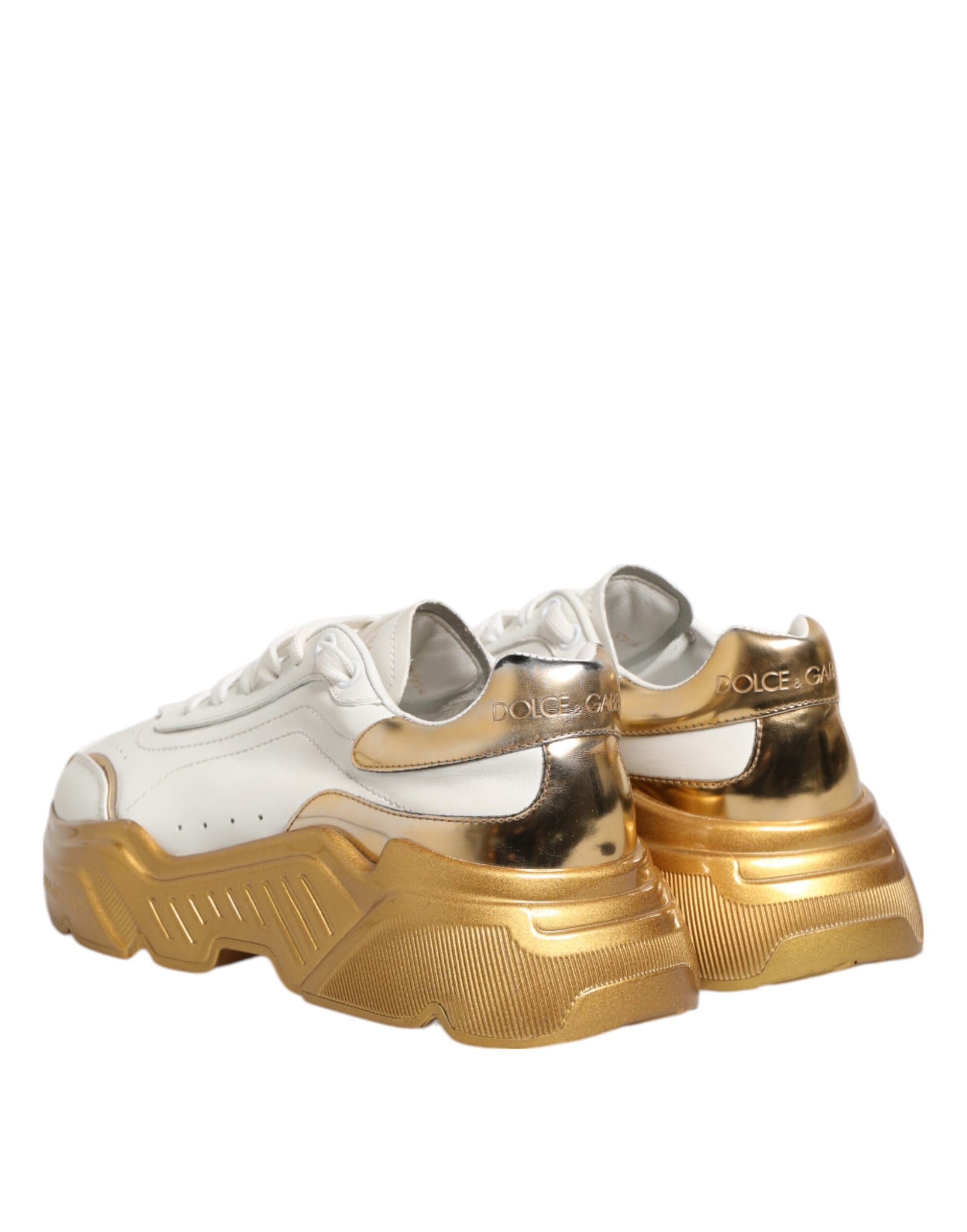 Pair of white gold women's sneakers with laces and a logo on the side