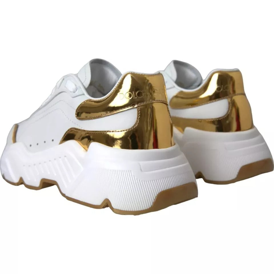 Pair of white sneakers with gold accents