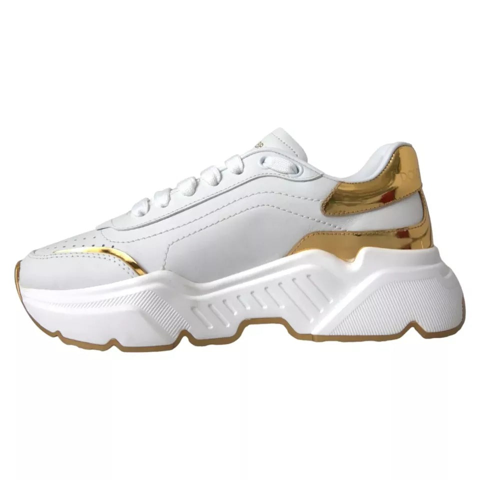 White sneaker with gold accents on sole and laces
