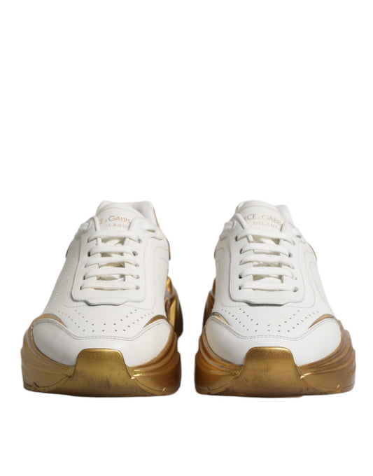 Pair of white gold D&G sneakers with laces and logo on side