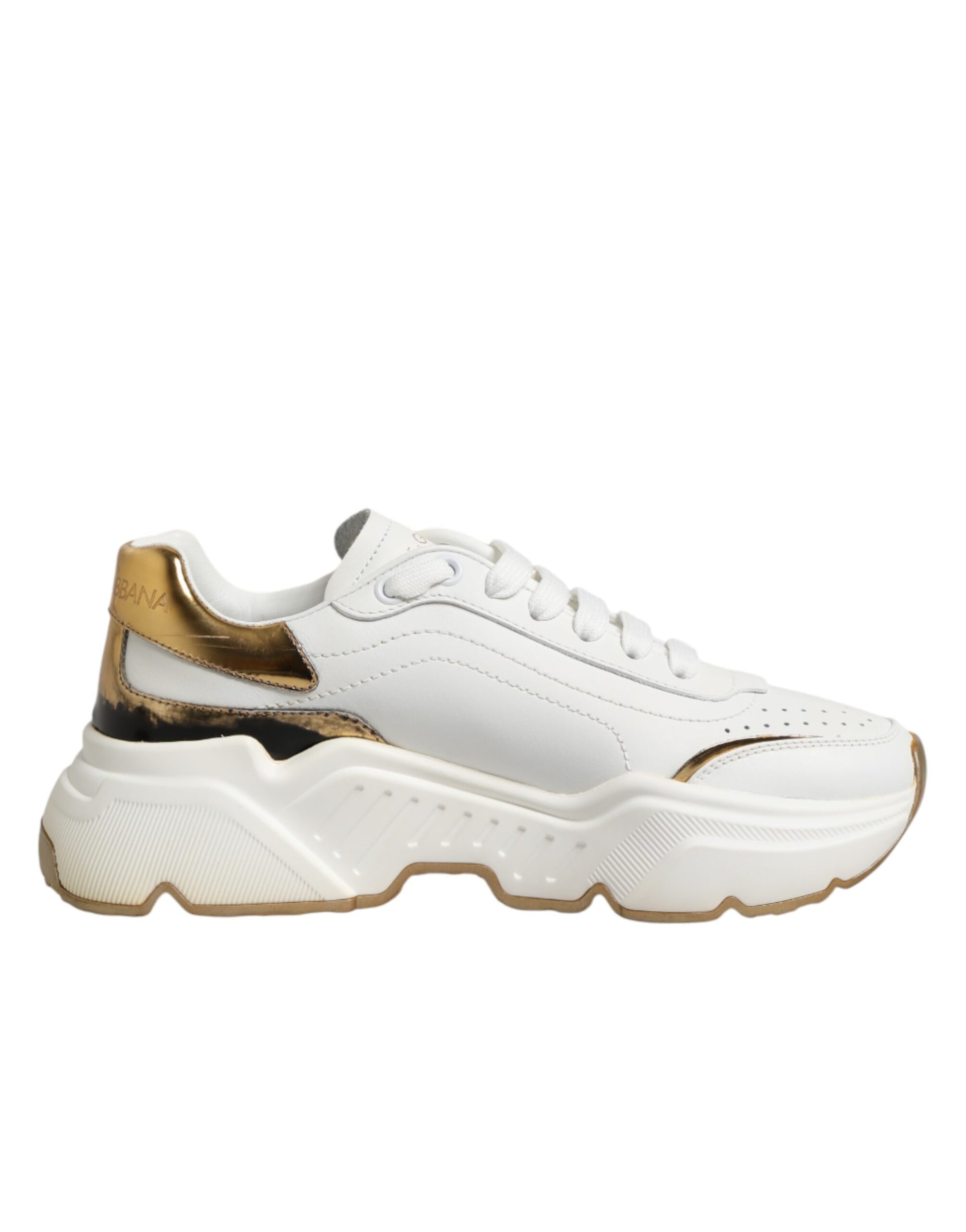 A pair of white gold sneakers with a low top, featuring a chunky sole and a logo on the side