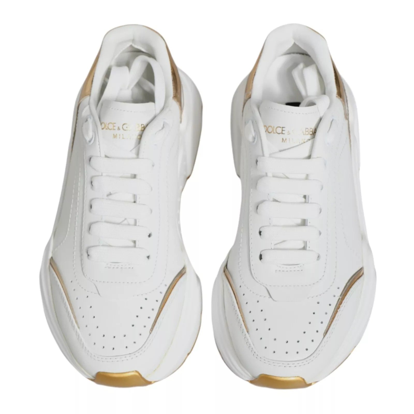 Pair of white sneakers with gold accents