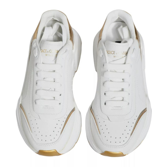 Pair of white sneakers with gold accents