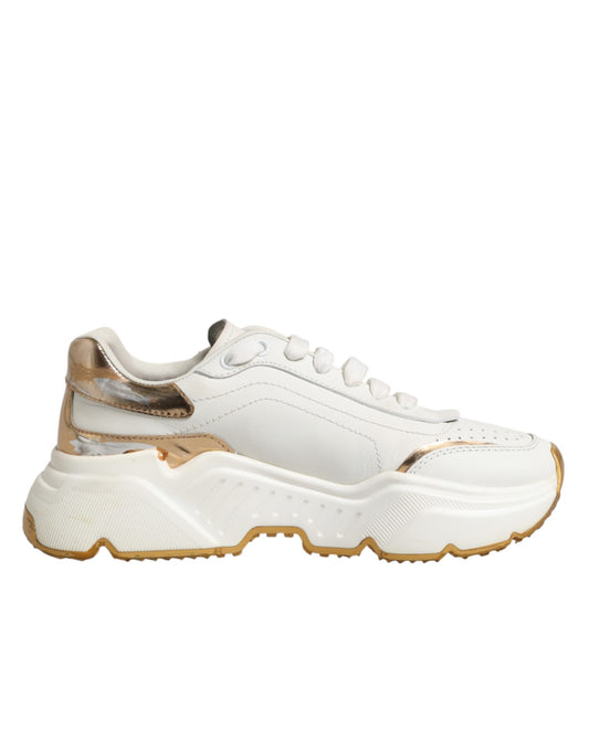 White gold sneakers with laces, featuring a low top and chunky sole design
