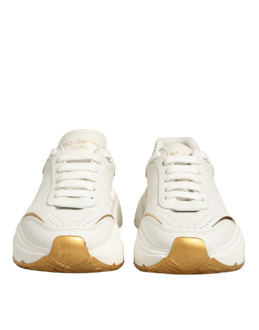 Pair of white sneakers with gold accents