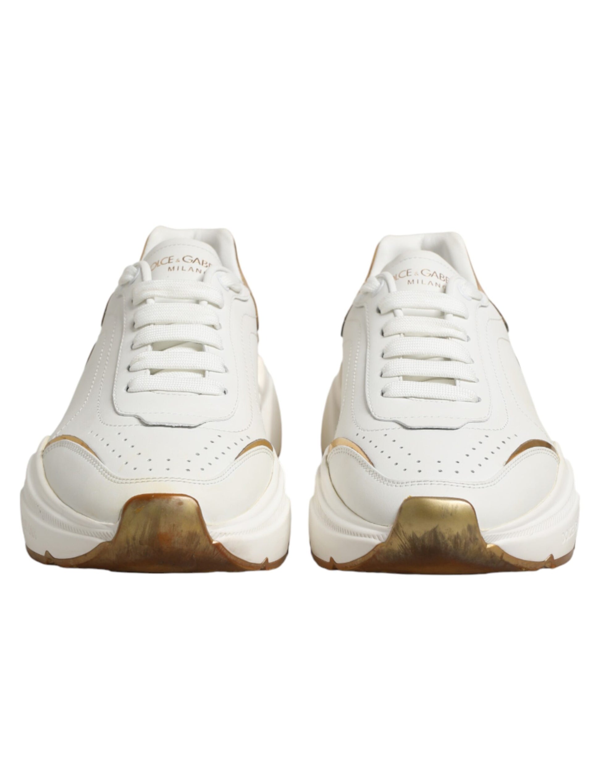 Pair of white gold sneakers with laces, featuring a low top design and a logo on the side