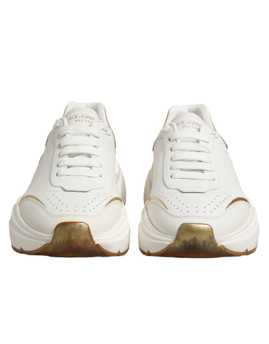 Pair of white gold sneakers with laces, featuring a low top design and a logo on the side