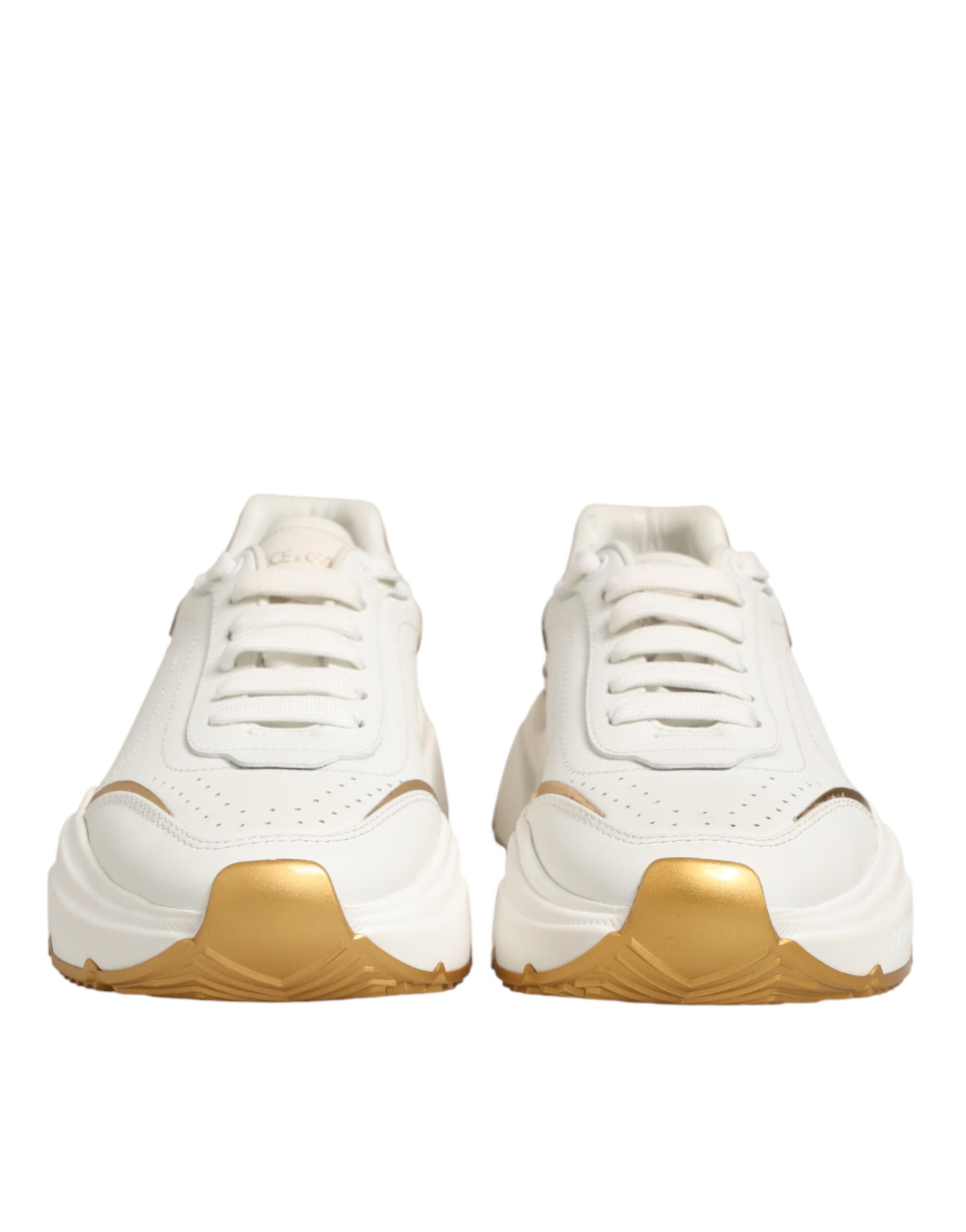 Pair of white sneakers with gold accents