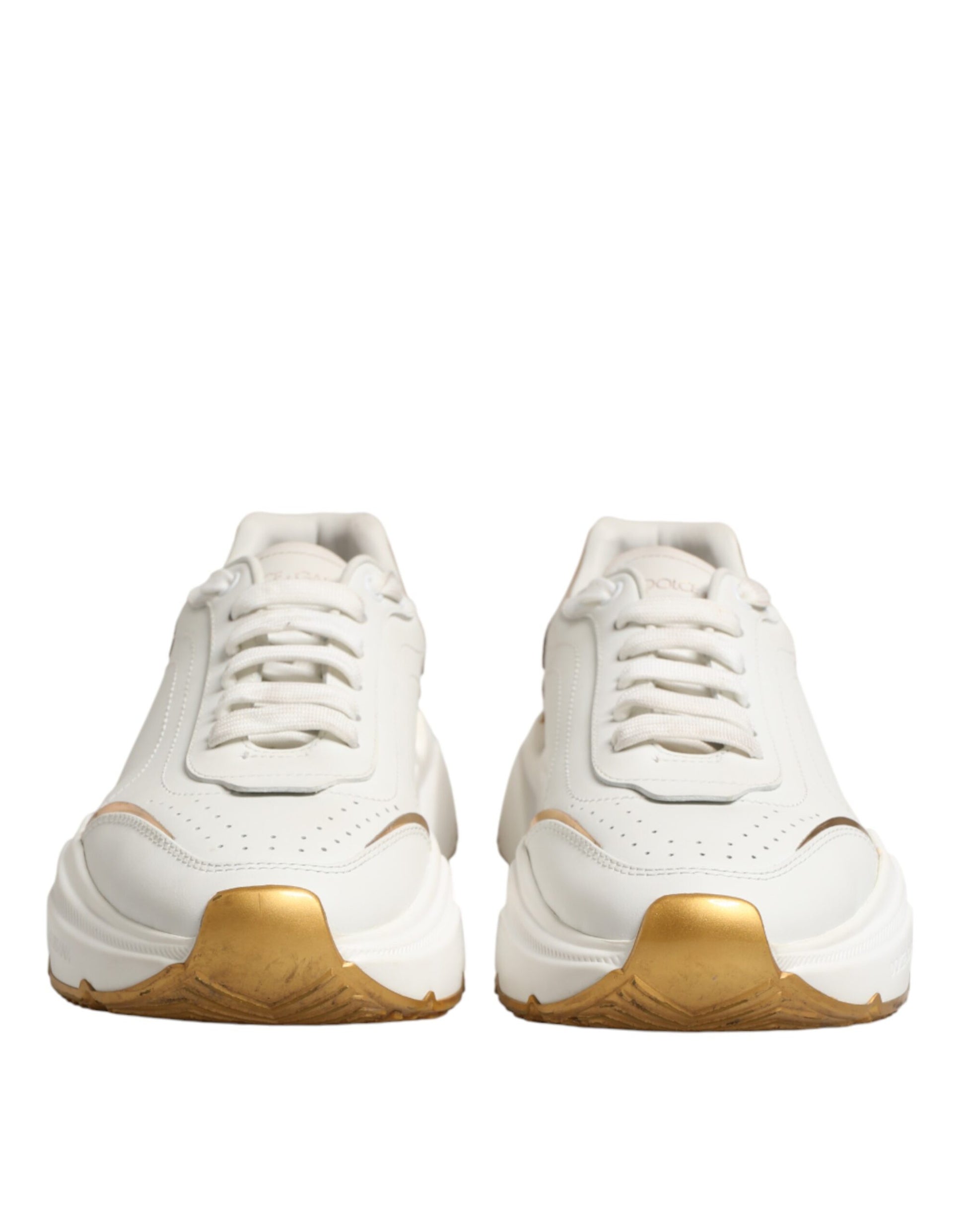 Pair of white sneakers with gold accents