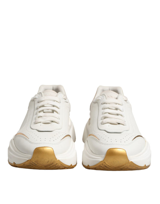 Pair of white sneakers with gold accents