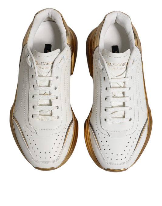 Pair of white gold D&G sneakers with low top, laces and logo on side