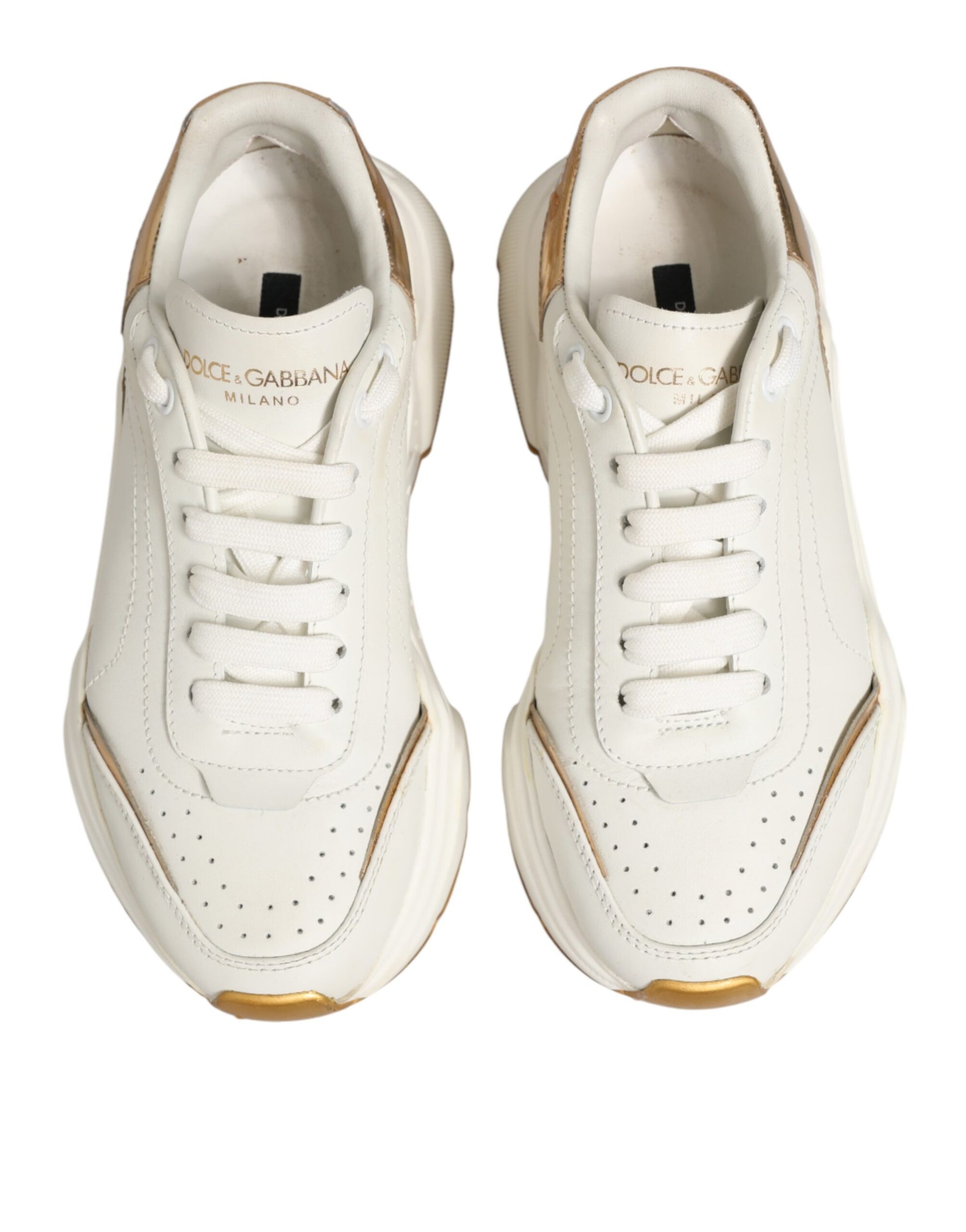 Pair of white sneakers with gold accents