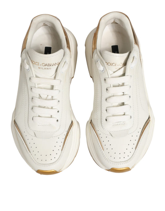 Pair of white sneakers with gold accents