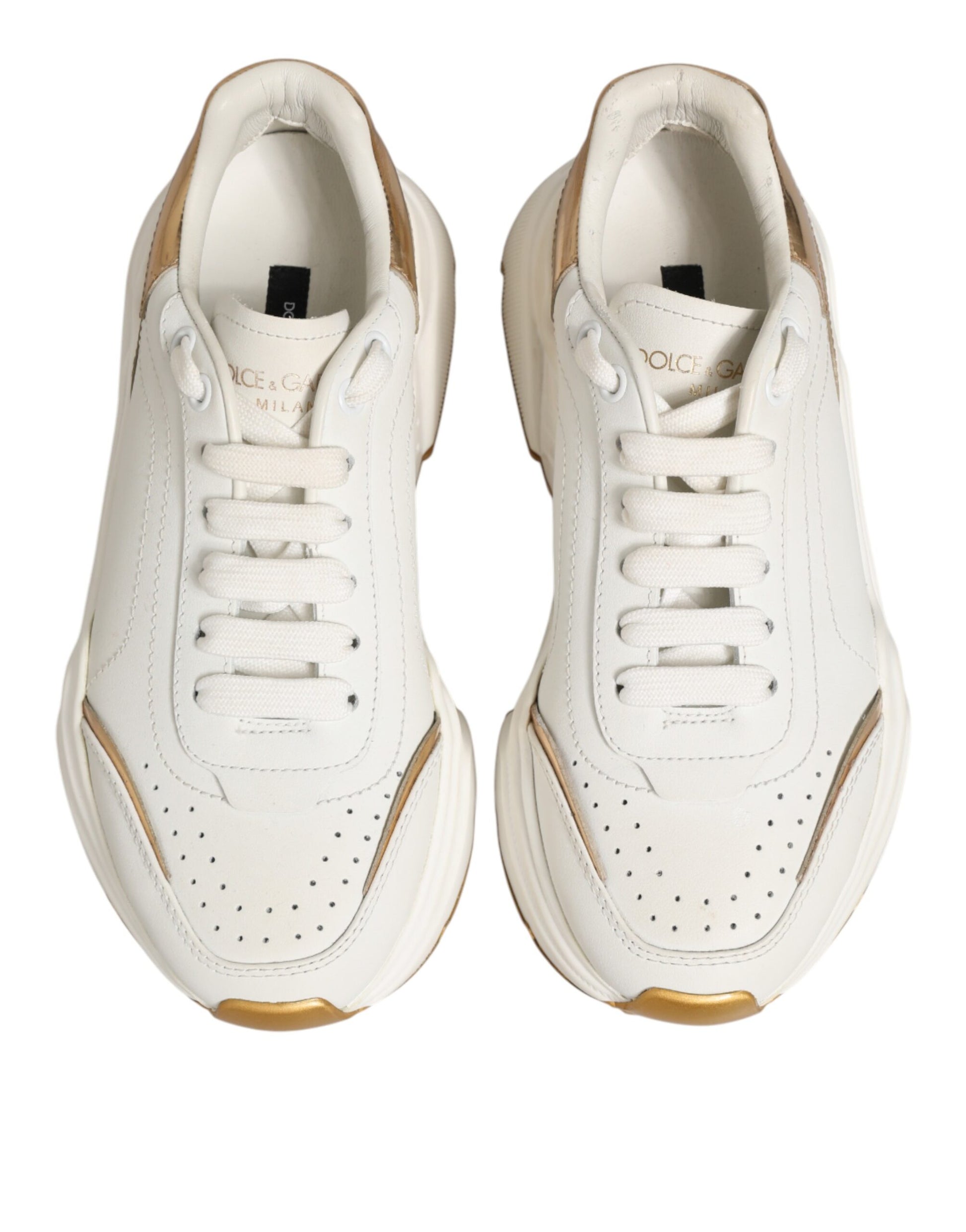 Pair of white sneakers with gold accents