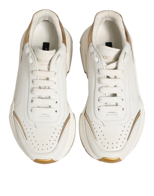 Pair of white sneakers with gold accents