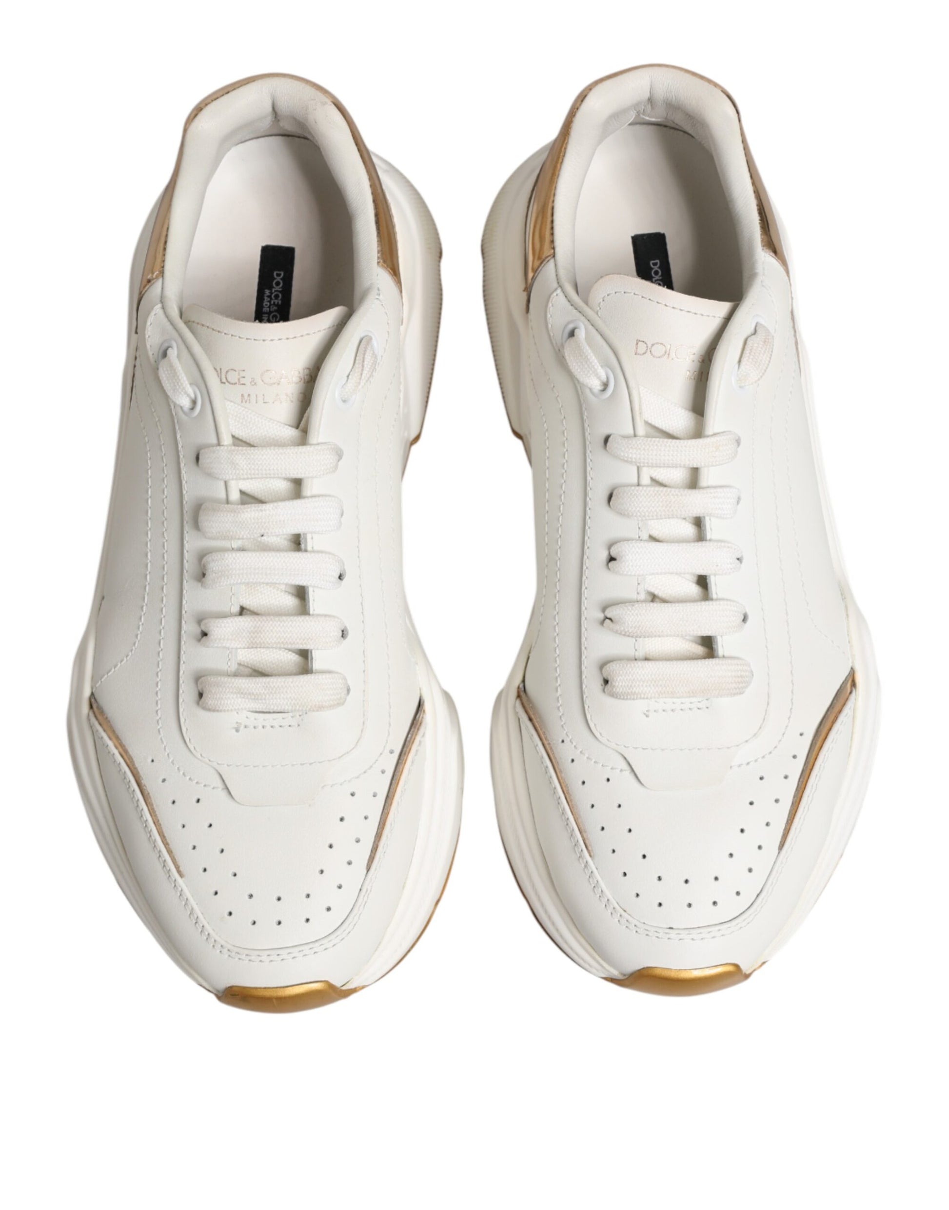 Pair of white sneakers with gold accents