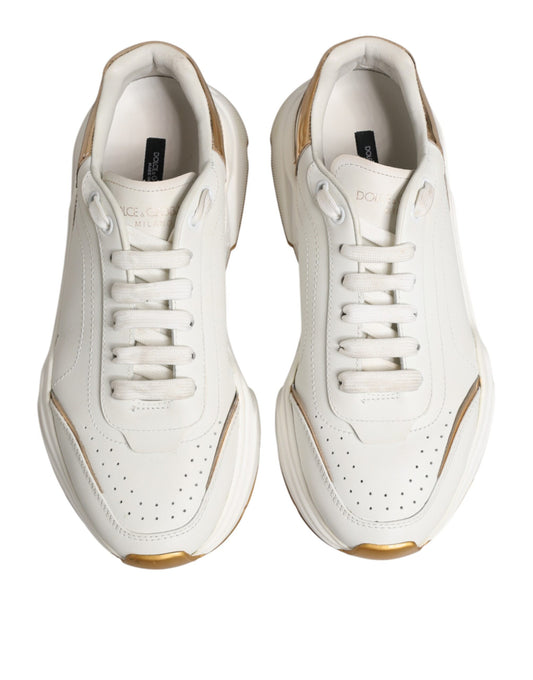 Pair of white sneakers with gold accents