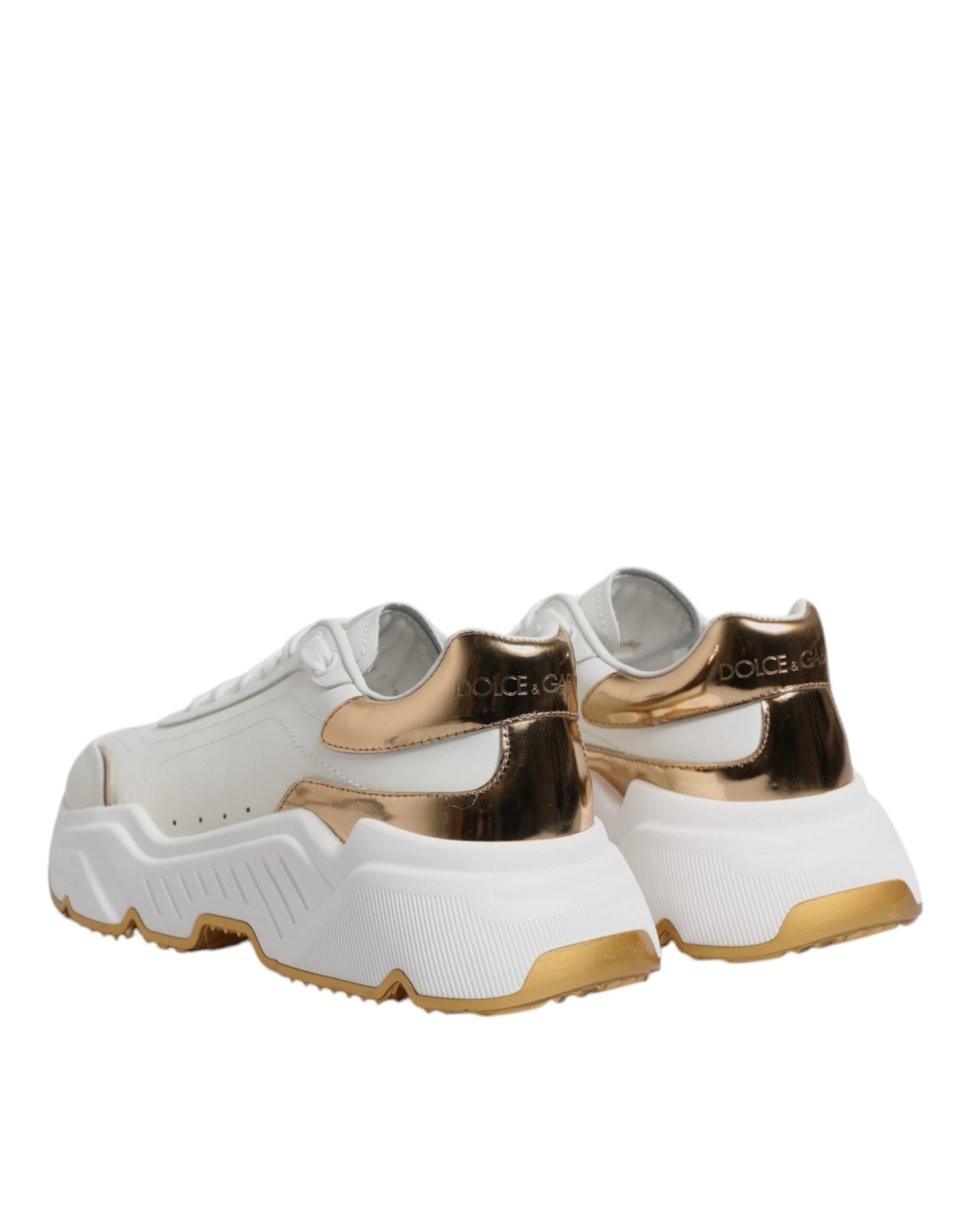 Pair of white sneakers with gold accents