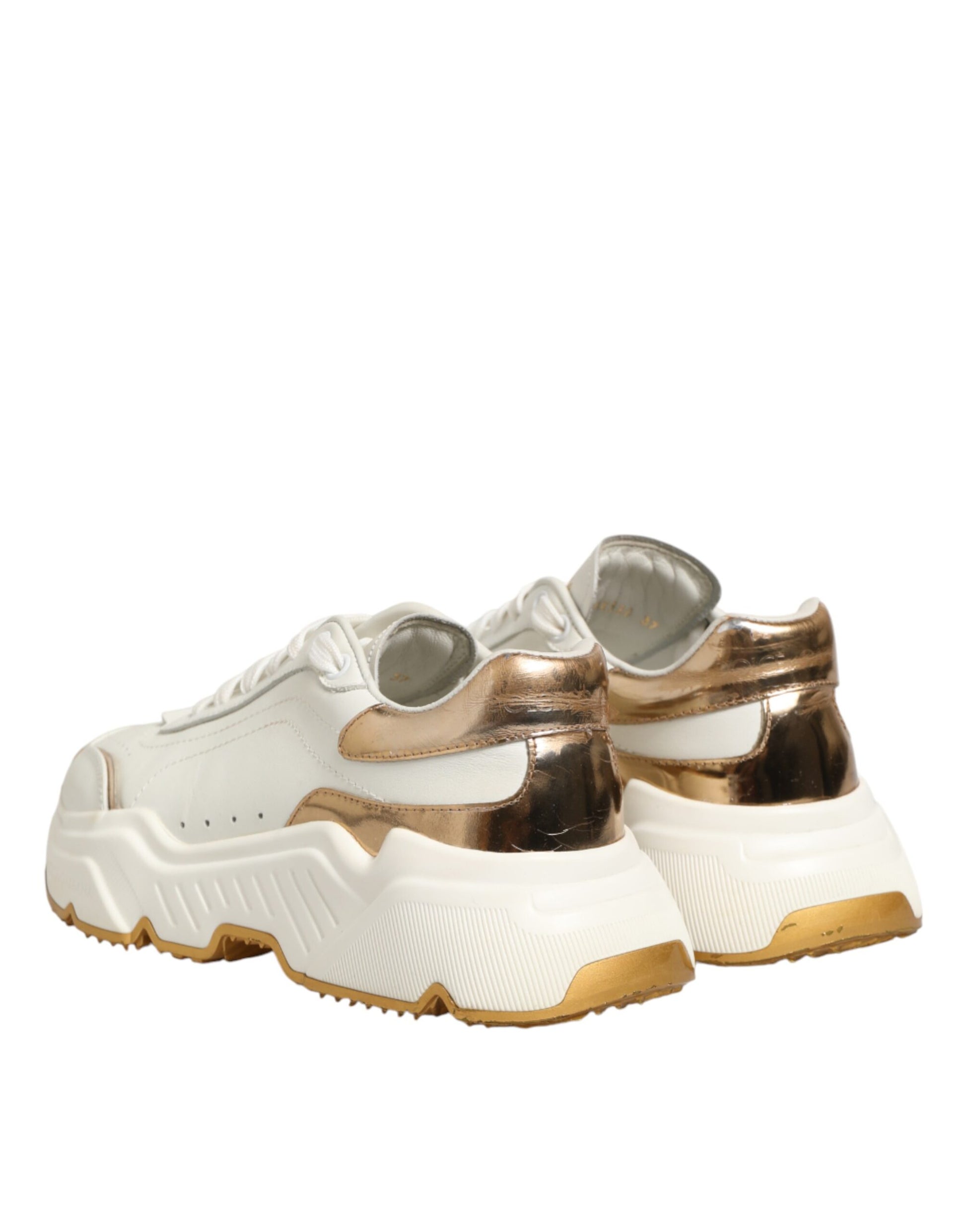 Pair of white sneakers with gold accents