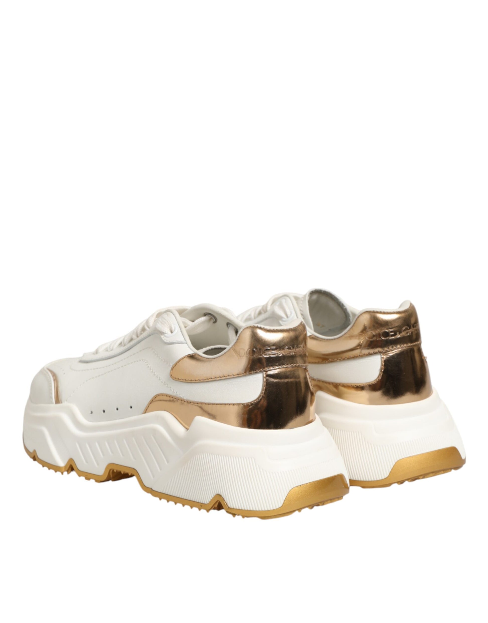 Pair of white sneakers with gold accents