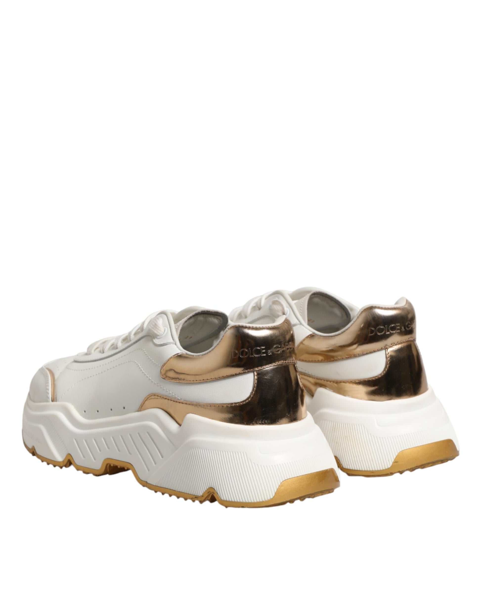 Pair of white sneakers with gold accents