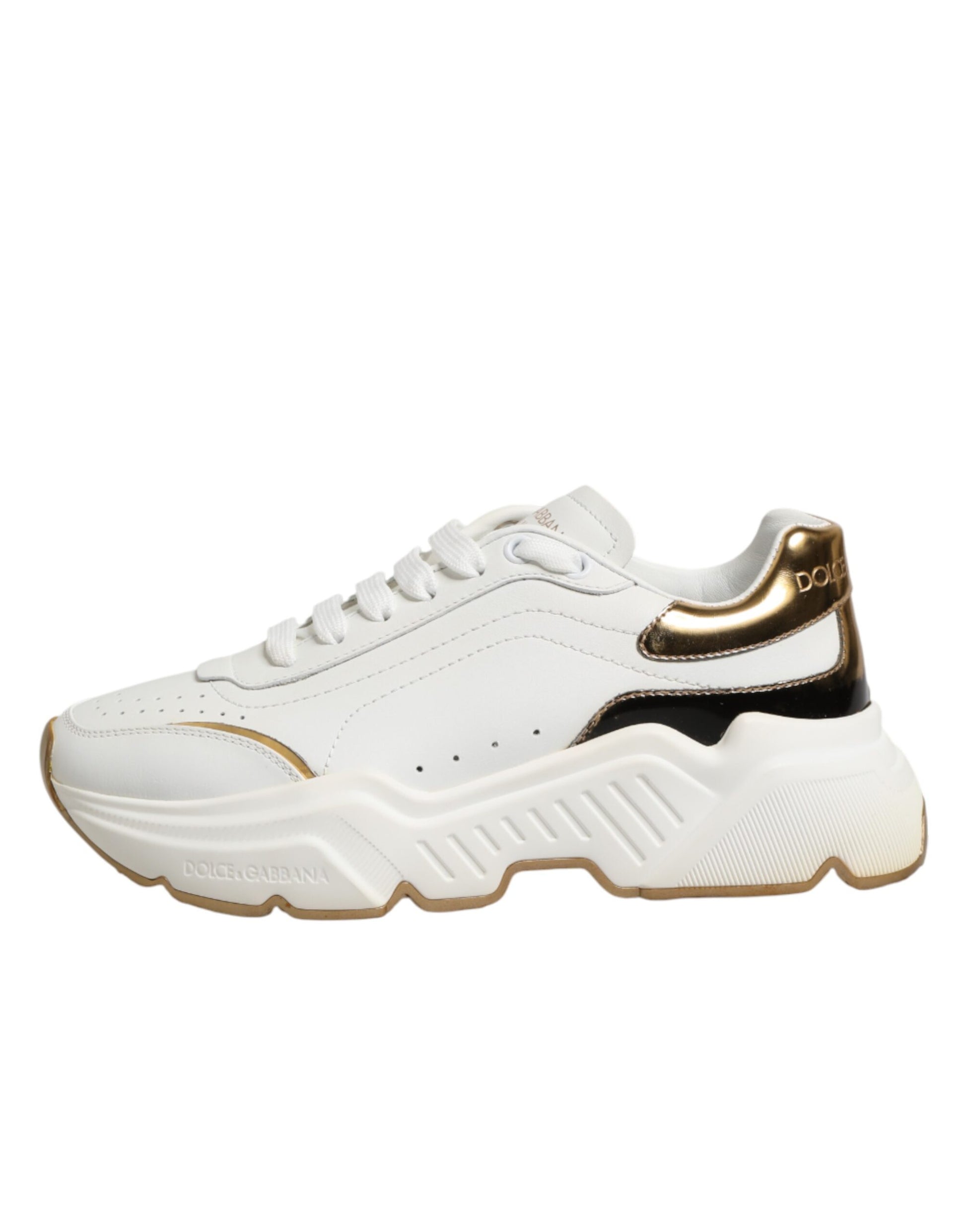 White gold low top sneakers with black laces, featuring a logo on the side and a chunky sole