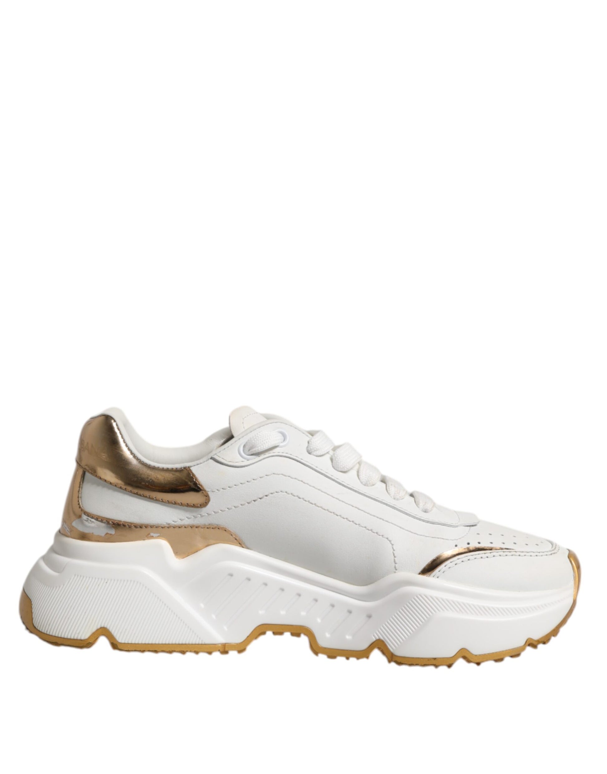 White gold low top sneakers with laces, featuring a chunky sole and a logo on the side