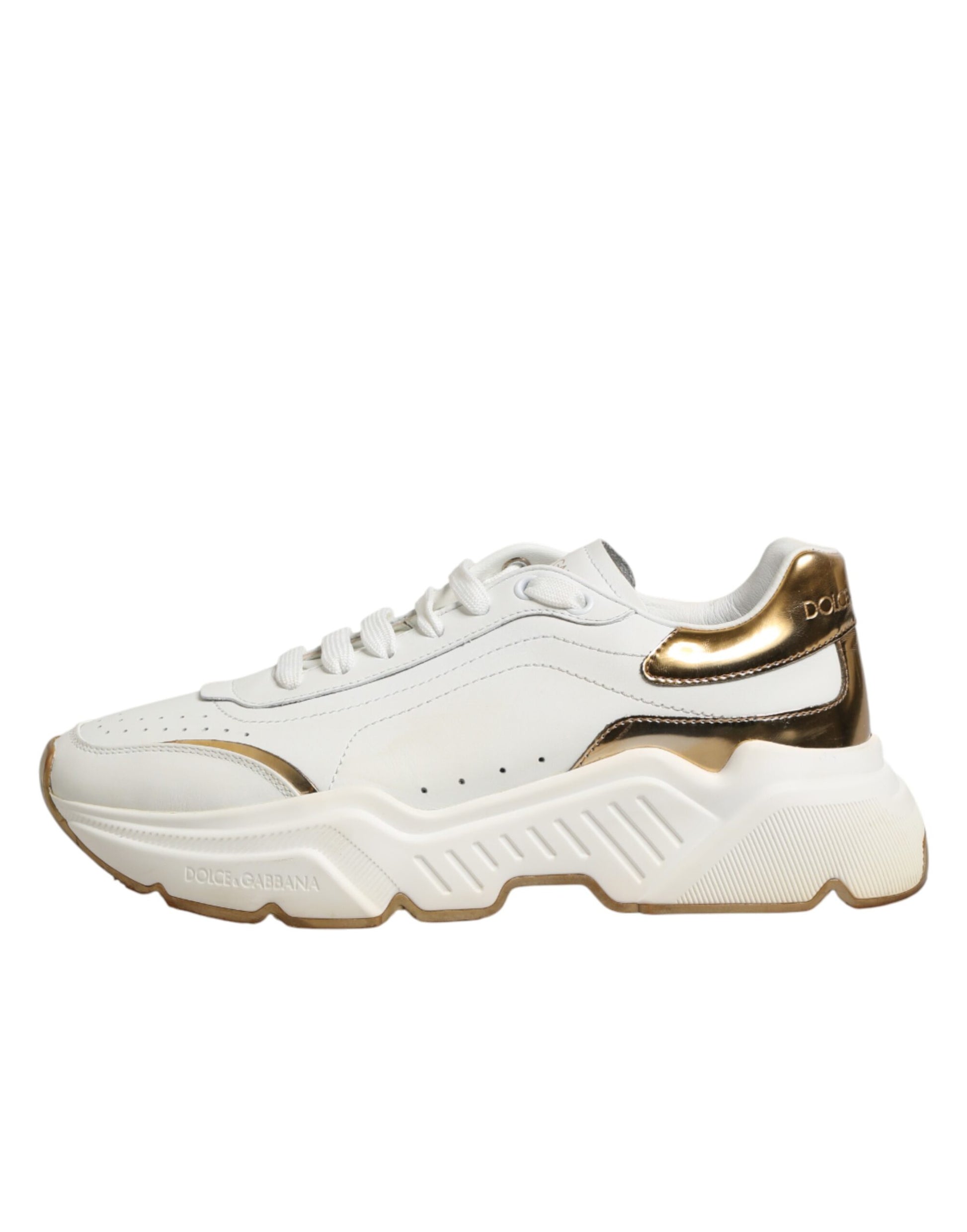 White gold low top sneakers with laces, featuring a logo on the side and a chunky sole