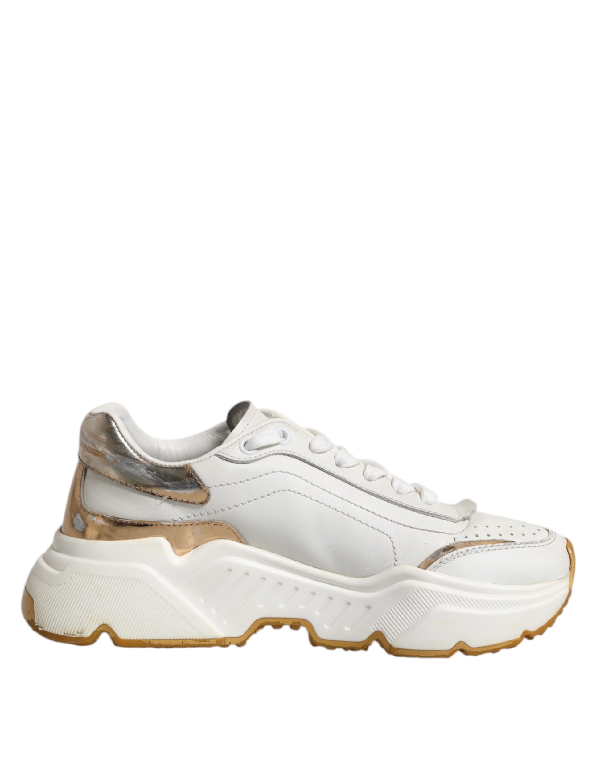 White gold low top sneakers with laces, featuring a chunky sole and a logo on the side
