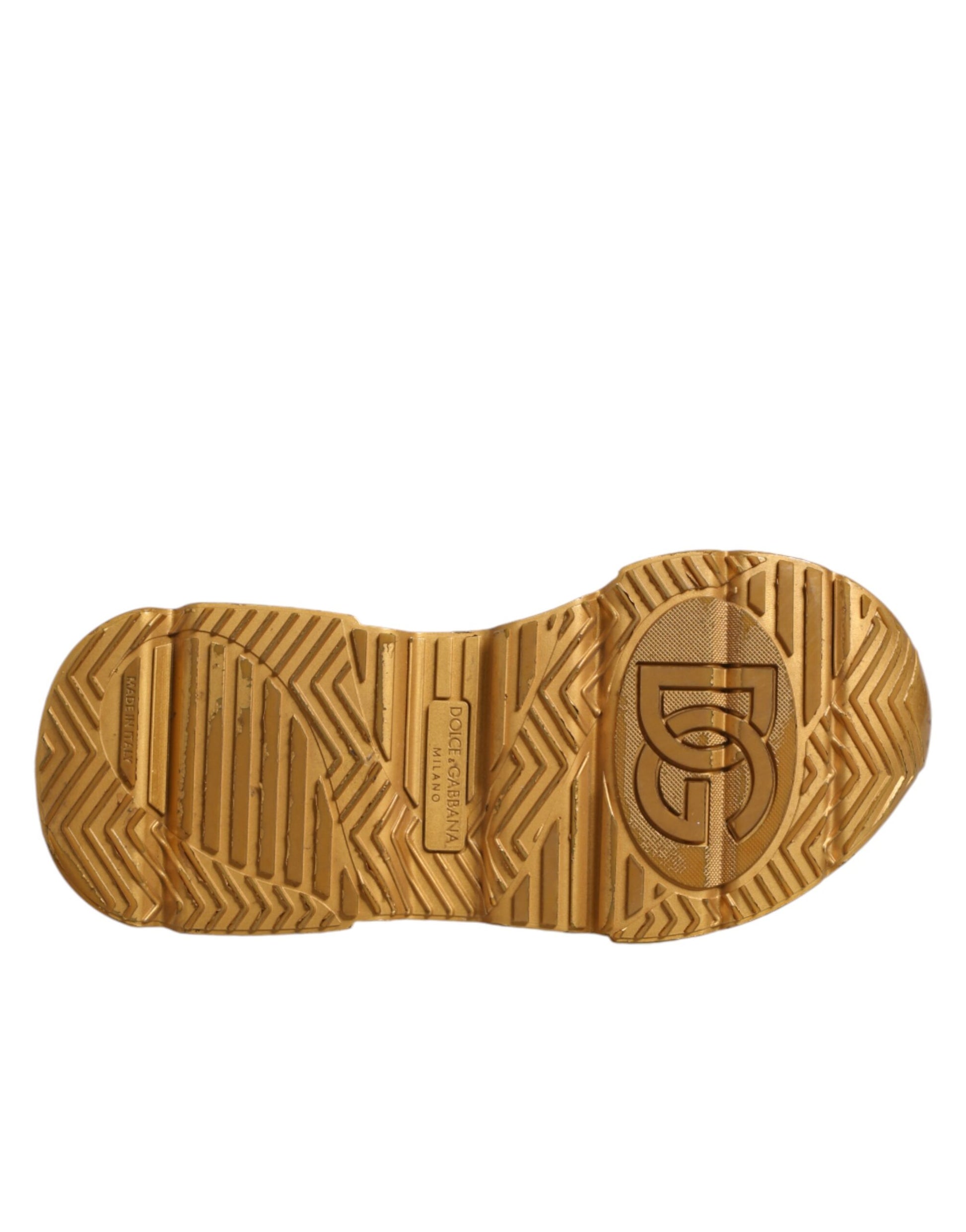 A pair of white gold sneakers with a low top, featuring the Dolce & Gabbana logo