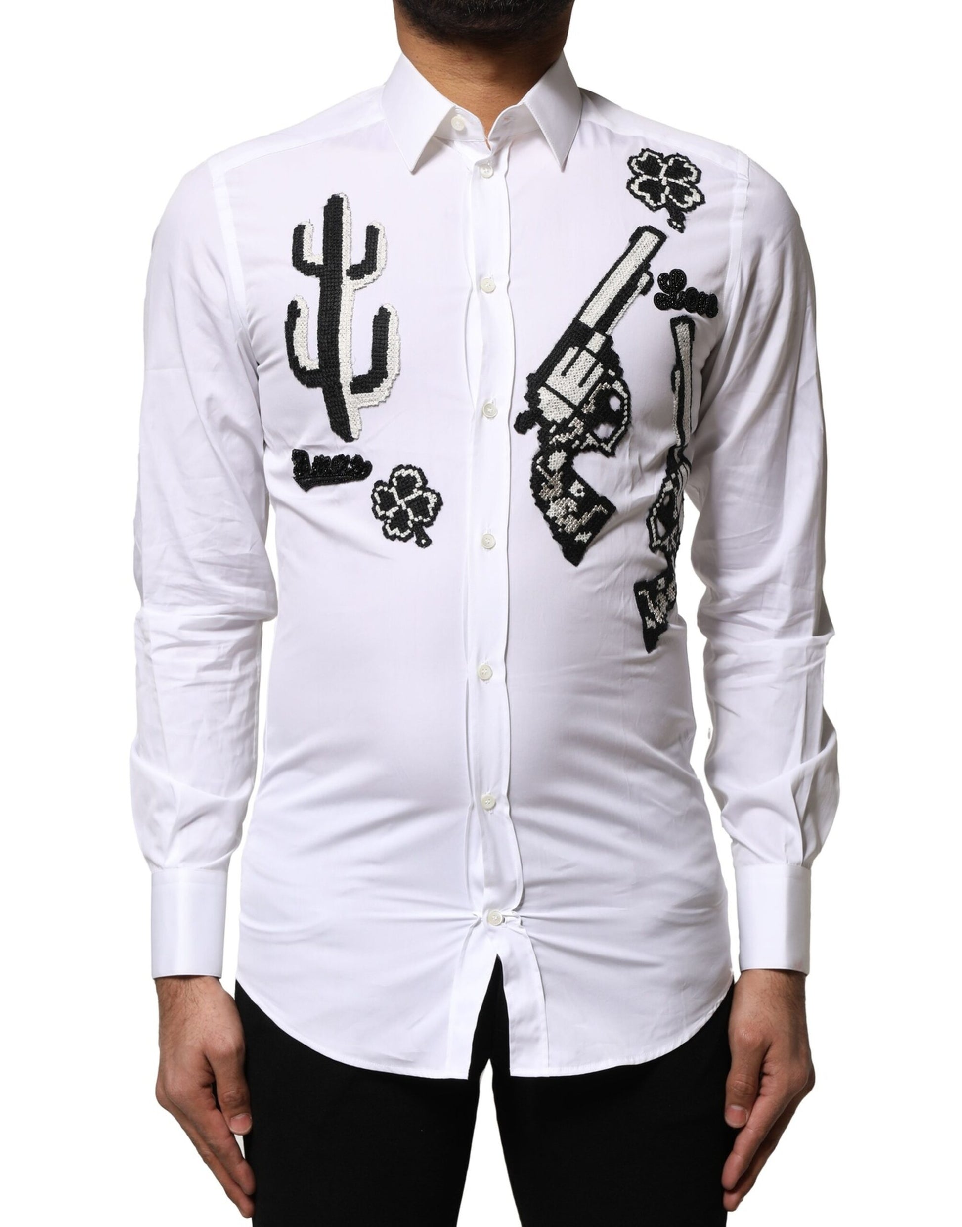 A white dress shirt with gold embroidery detailing on the front
